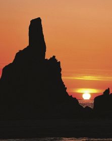 橋杭岩の大オガミ岩（左）と共演する「だるま朝日」（２２日午前５時２０分、和歌山県串本町くじの川で）