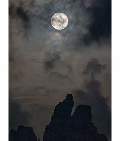 橋杭岩の上空で輝いた「スーパーブルームーン」とも呼ばれる、いつもより大きな月（８月３１日午後７時２９分、和歌山県串本町くじの川で）