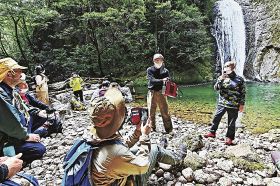 二の滝の前で、和歌山の水の美しさを力説する内山りゅうさん（右）＝和歌山県那智勝浦町で