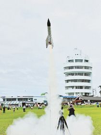 串本町で前回開かれた缶サット甲子園で、白煙を上げながら飛び立つロケット（２０２１年７月、和歌山県串本町潮岬で）
