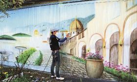 イタリアの町並みをイメージした壁画を描く柴田友助さん