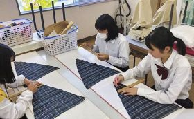「ＡＥＤハートフルシート」を制作する熊野高校Ｋｕｍａｎｏサポーターズリーダー部の生徒（和歌山県上富田町朝来で）