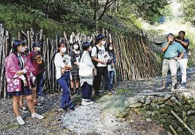 製炭士の話を聞く神島高校の生徒（左の２人）＝１０月、和歌山県みなべ町清川で