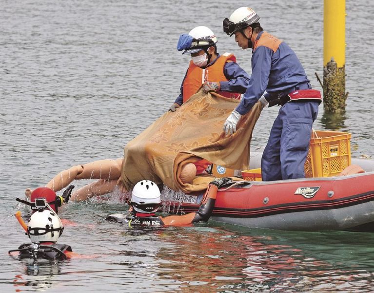 要救助者に見立てた人形をボートに引き上げる署員（１７日、和歌山県すさみ町周参見で）