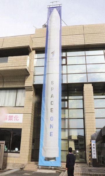 串本町役場古座分庁舎正面に設置された高さ１８メートルの実物大ロケットの懸垂幕（１２日、和歌山県串本町西向で）