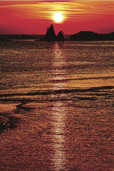 熊野灘から弁天島の上に昇った太陽が、水面に光の道を作った（１日午前６時１９分、那智勝浦町で）
